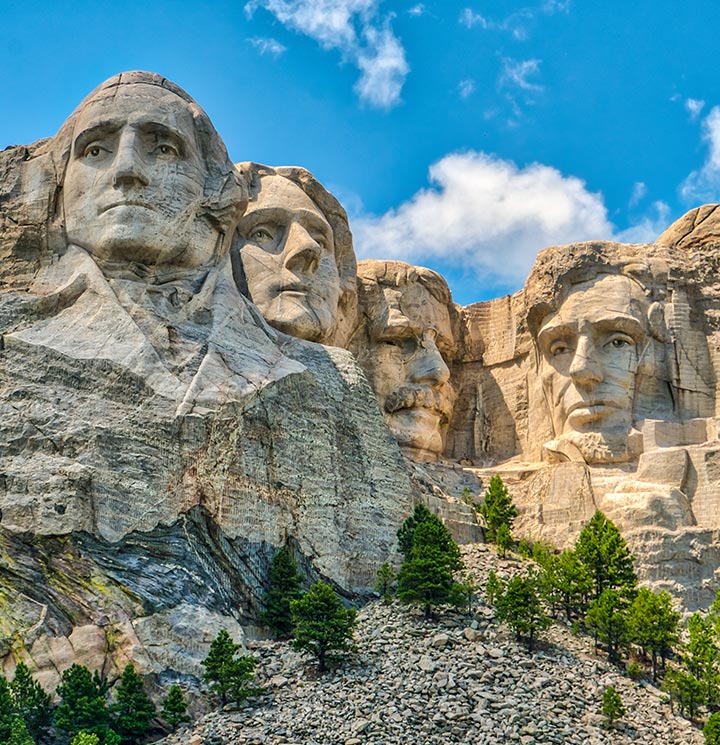 Mount Rushmore with four presidential faces carved into the stone.